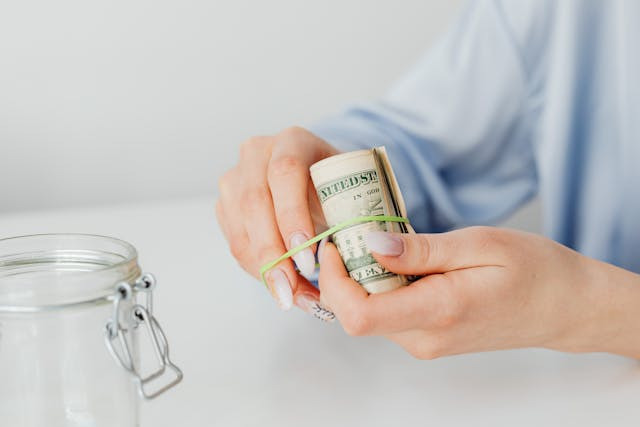 person-putting-money-in-jar