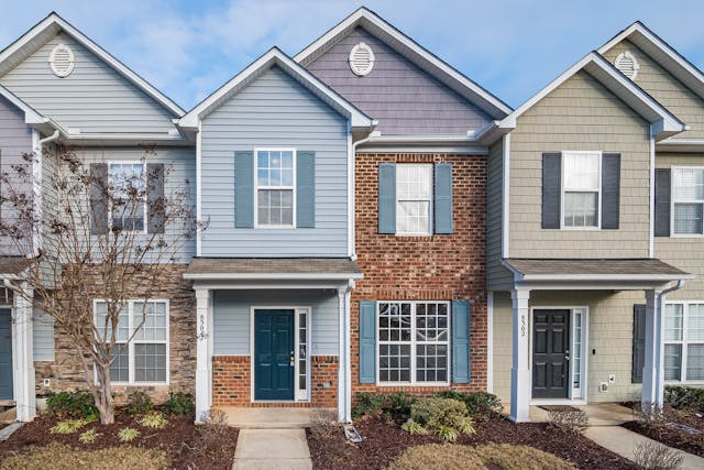 duplexes with blue sky and lawn